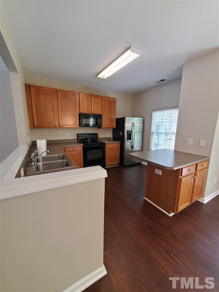 8208 Clasara Circle Raleigh, NC 27613 - Photo 6 of 26 a living room with furniture and a flat screen tv