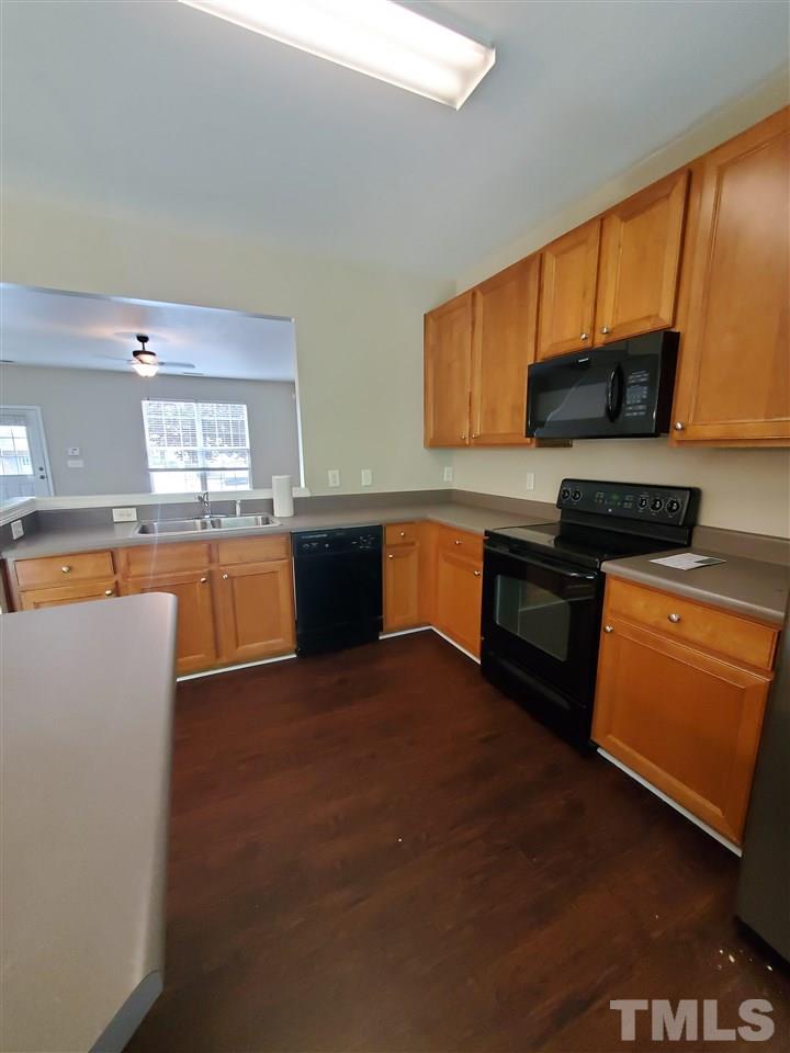8208 Clasara Circle Raleigh, NC 27613 - Photo 7 of 26 a kitchen with stainless steel appliances granite countertop a stove a sink and a refrigerator