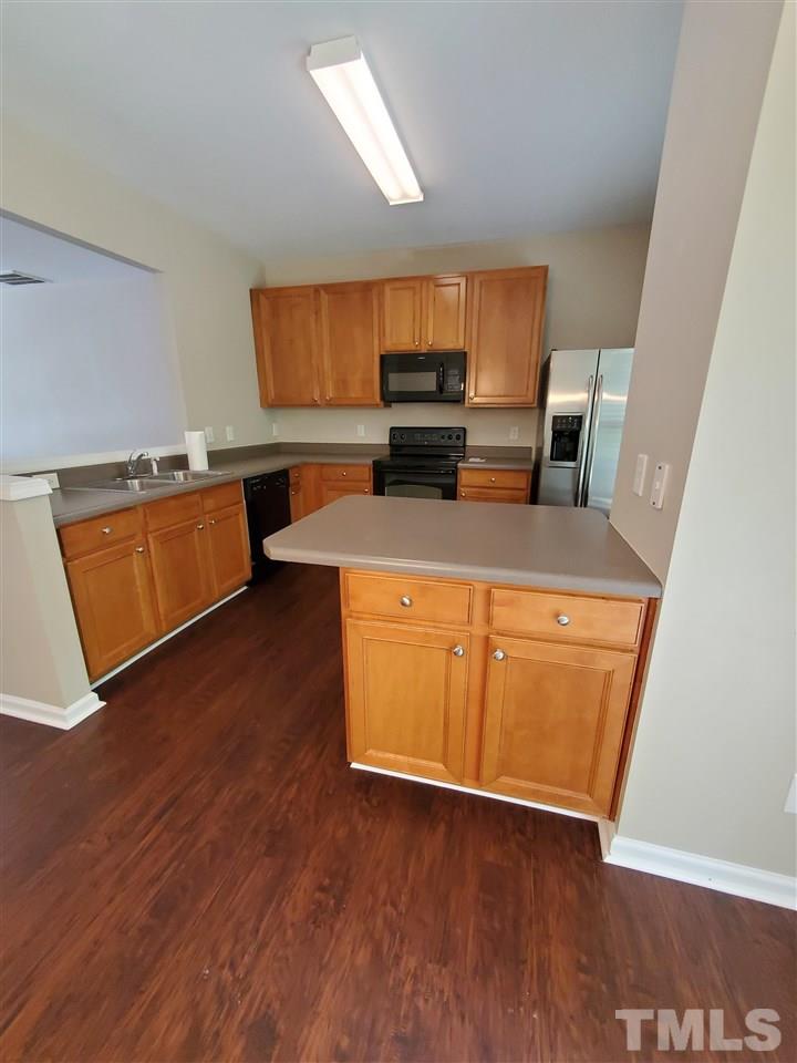 8208 Clasara Circle Raleigh, NC 27613 - Photo 8 of 26 a kitchen with wooden floors and a sink