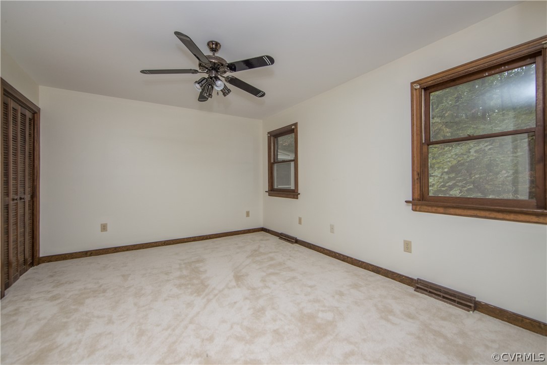 6400 Qualla Road Chesterfield, VA 23832 - Photo 19 of 36 an empty room with a window and ceiling fan