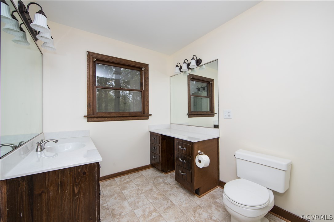 6400 Qualla Road Chesterfield, VA 23832 - Photo 23 of 36 a bathroom with a toilet a sink and mirror