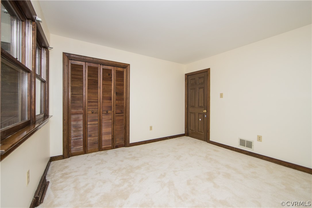 6400 Qualla Road Chesterfield, VA 23832 - Photo 27 of 36 a view of an empty room with wooden floor and a window