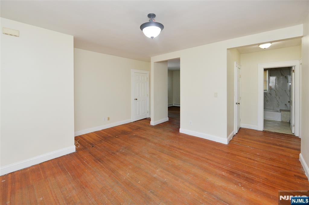 62 Broadway, Unit 1 Hackensack, NJ 07601 - Photo 12 of 25 a view of an empty room with window and wooden floor