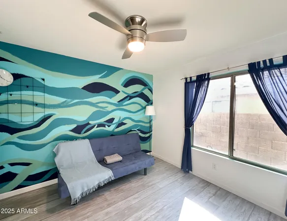 a living room with a bed and a window