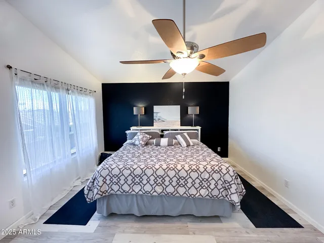 a bedroom with a bed and a window