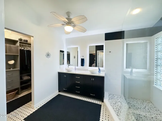 a spacious bathroom with a double vanity sink and a mirror