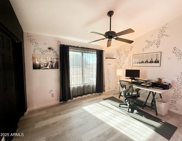 a bedroom with a bed and a desk