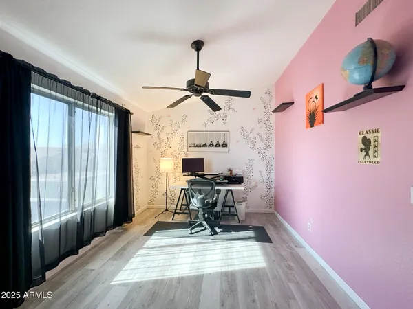 a bedroom with a bed chandelier and a window