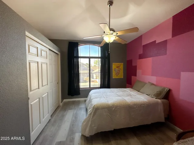 a bedroom with a bed and a chandelier