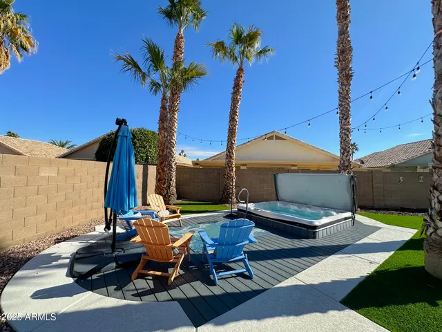 a view of a patio with table and chairs under an umbrella