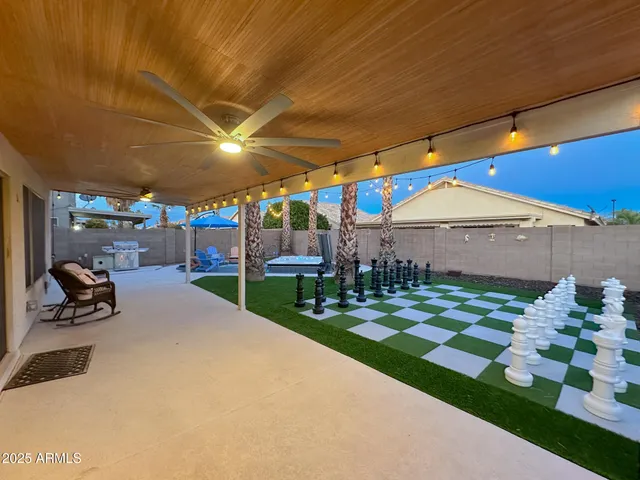 a view of a roof deck with table and chairs under an umbrella
