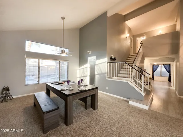 a dining room with furniture wooden floor and a chandelier