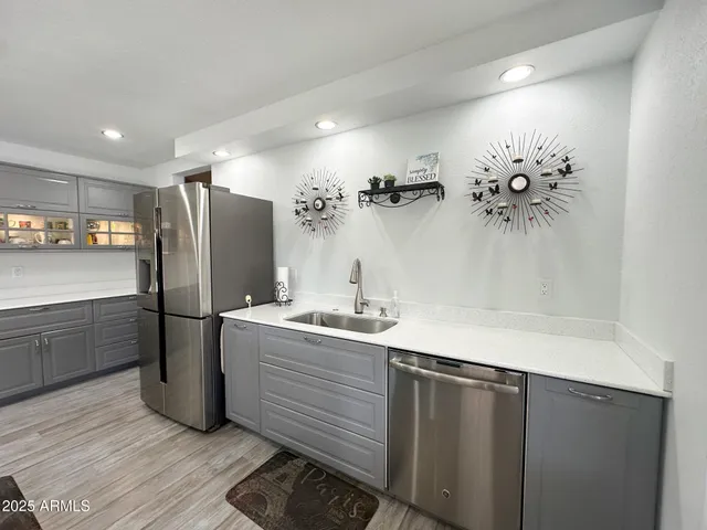 a kitchen with a refrigerator and a sink