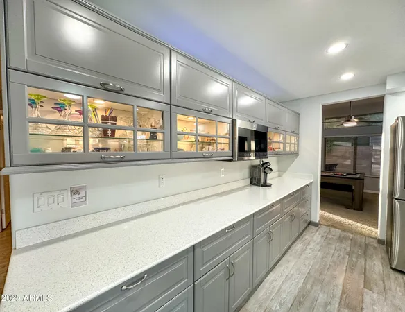 a large kitchen with a large counter top and stainless steel appliances