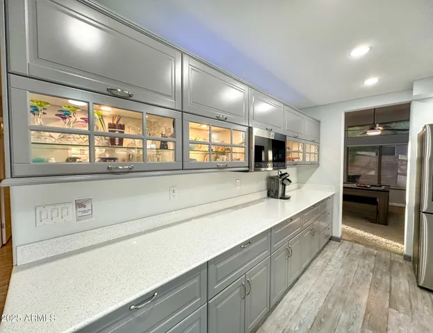 a large kitchen with a large counter top and stainless steel appliances