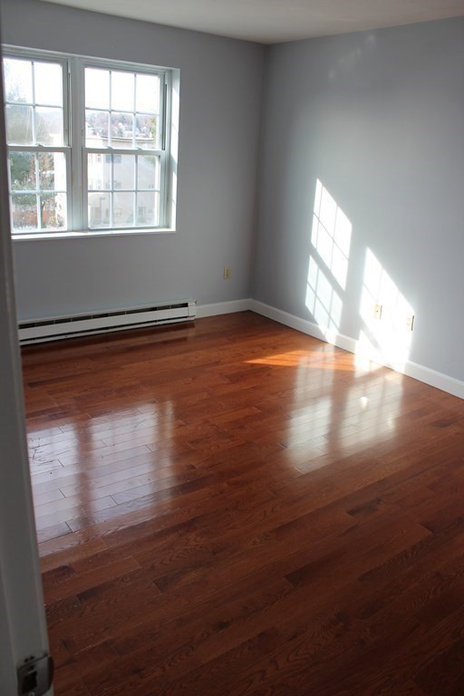 36 C Gibbs Street, Unit 29 Worcester, MA 01607 - Photo 17 of 25 a view of empty room with wooden floor and fan