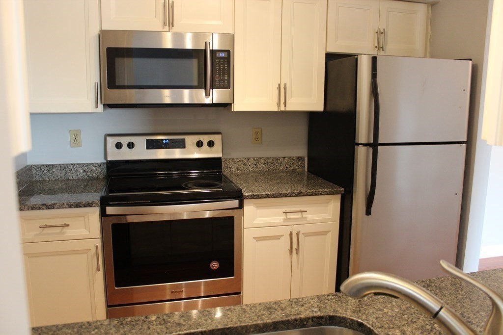 36 C Gibbs Street, Unit 29 Worcester, MA 01607 - Photo 3 of 25 a kitchen with a stove microwave and refrigerator