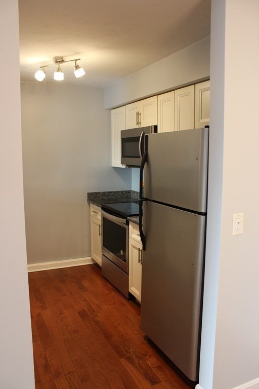 36 C Gibbs Street, Unit 29 Worcester, MA 01607 - Photo 4 of 25 a kitchen with a refrigerator and a stove
