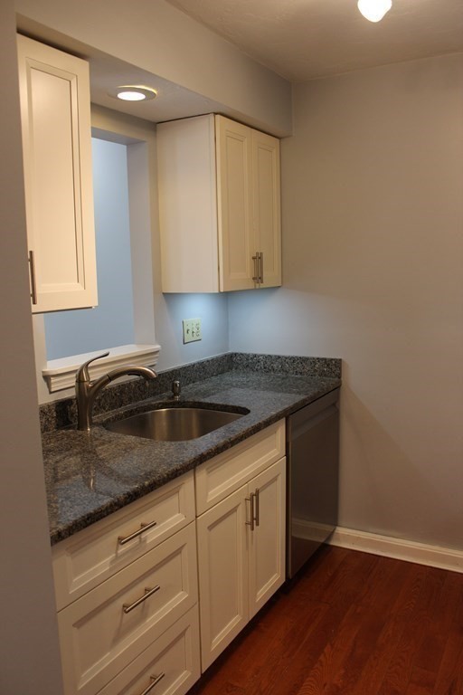 36 C Gibbs Street, Unit 29 Worcester, MA 01607 - Photo 6 of 25 a kitchen with granite countertop a sink and a stove top oven