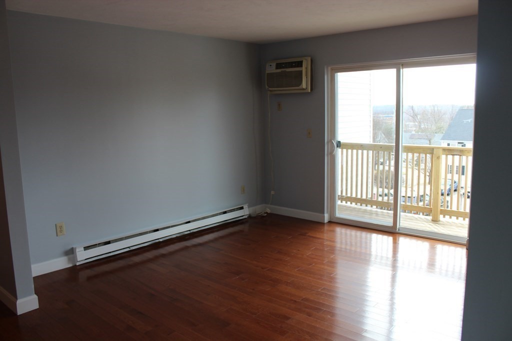 36 C Gibbs Street, Unit 29 Worcester, MA 01607 - Photo 10 of 25 a view of an empty room with wooden floor and a window