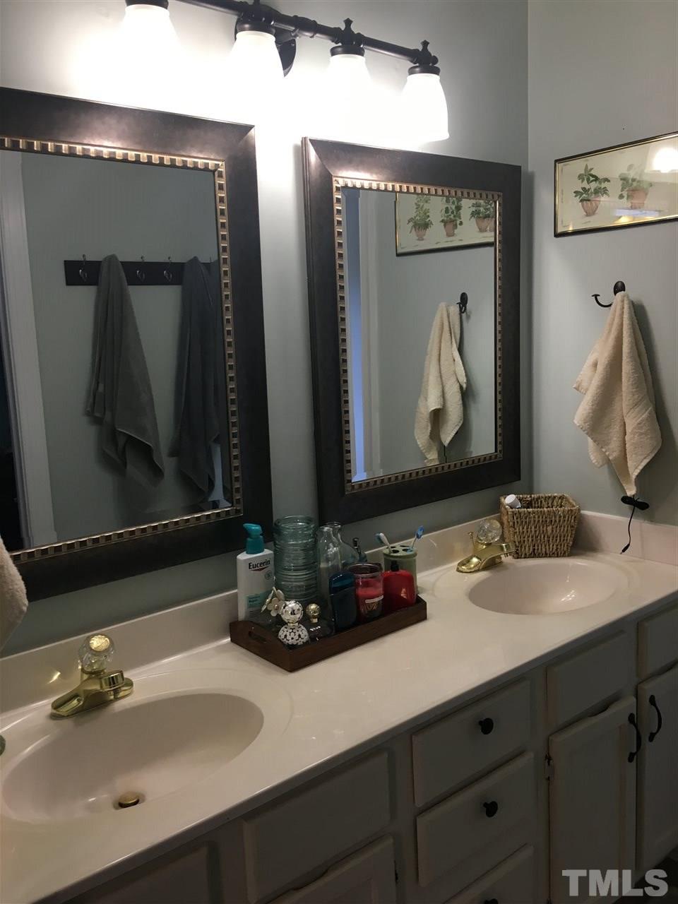 9412 Dawnshire Road Raleigh, NC 27615 - Photo 8 of 13 a bathroom with a sink and a mirror