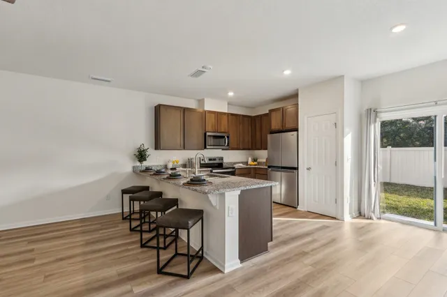 a kitchen with a table and chairs in it