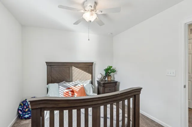 a bedroom with furniture and a potted plant
