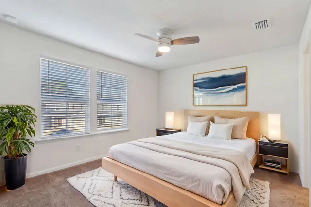 a bedroom with a large bed and a couch