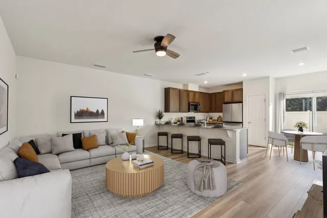 a living room with furniture kitchen view and a table
