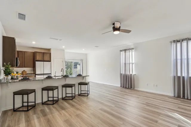 a view of a dining room with furniture and wooden floor