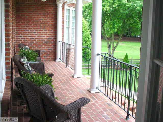 125 Suntree Road Advance, NC 27006 - Photo 3 of 16 Patio/Deck. Covered Rear Porch overlooks lush backdrop