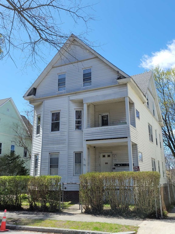 71 Paine Street Worcester, MA 01605 - Photo 1 of 20 a front view of a house with a yard