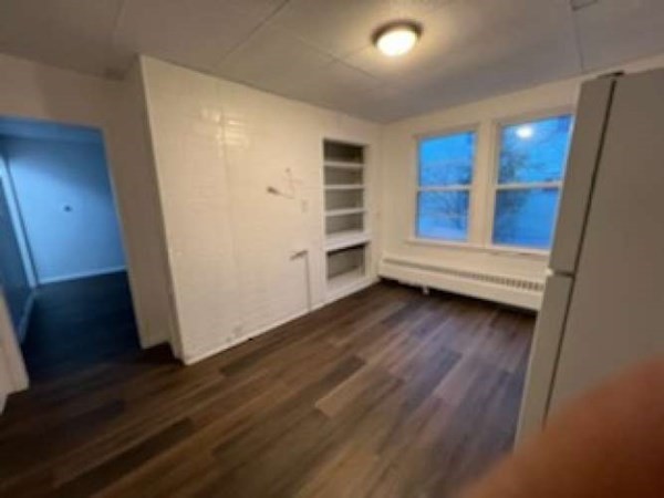 71 Paine Street Worcester, MA 01605 - Photo 12 of 20 a view of wooden floor and windows in a room