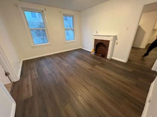 71 Paine Street Worcester, MA 01605 - Photo 13 of 20 a view of an empty room with wooden floor and a window