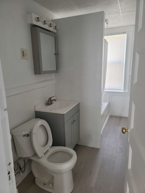 71 Paine Street Worcester, MA 01605 - Photo 16 of 20 a bathroom with a toilet sink and mirror