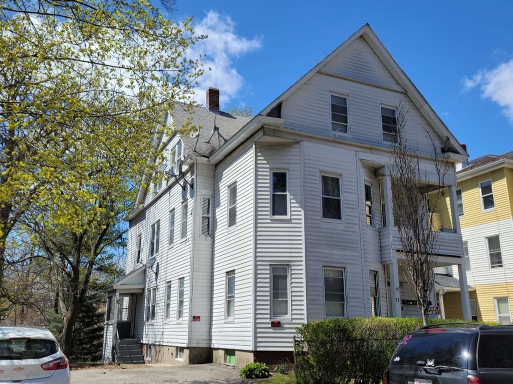 71 Paine Street Worcester, MA 01605 - Photo 2 of 20 a front view of a house with a yard