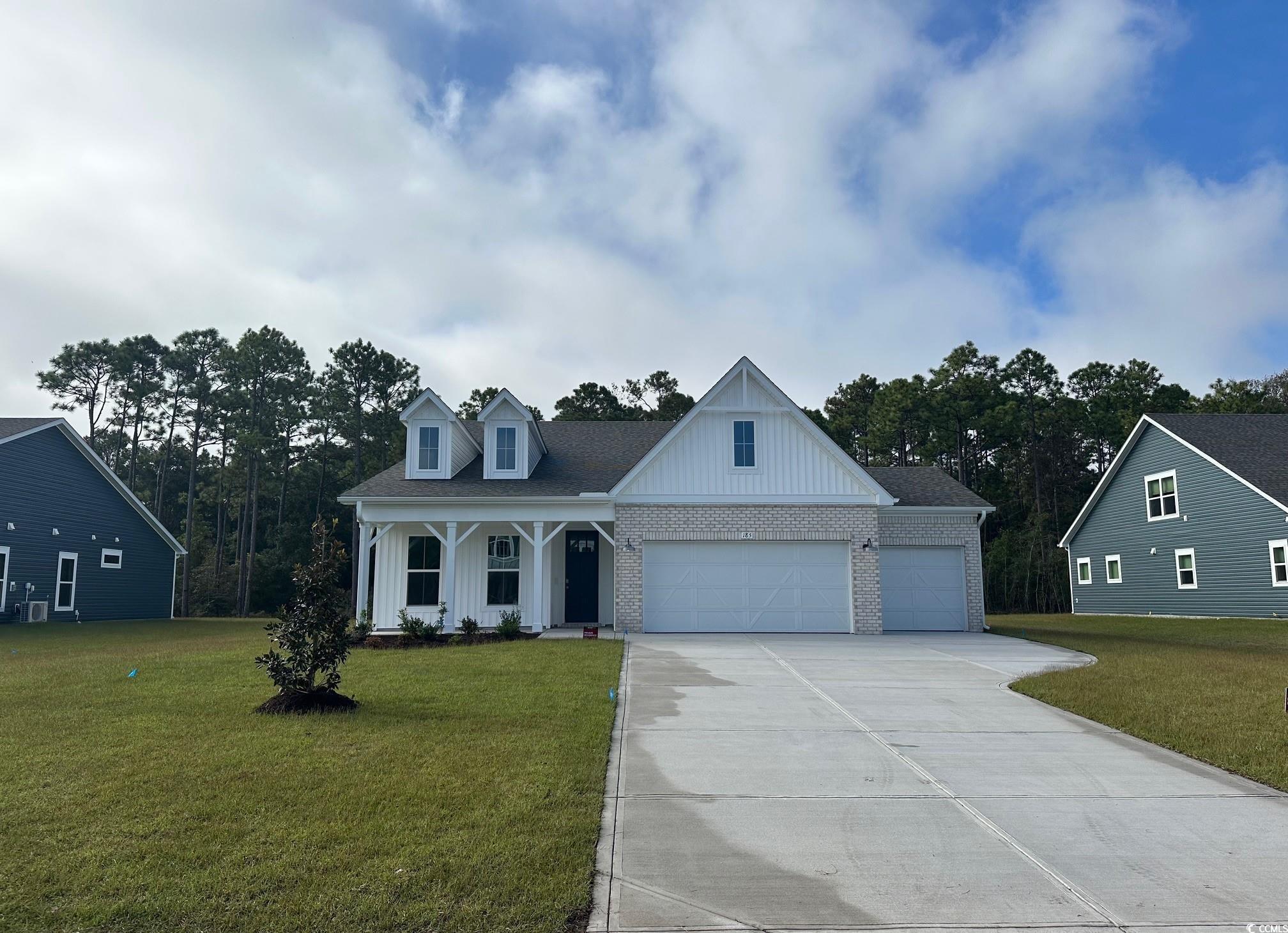 185 Northbrook Drive Murrells Inlet, SC 29576 - Photo 1 of 30 View of front of property with brick siding, a porch, board and batten siding, and a front yard