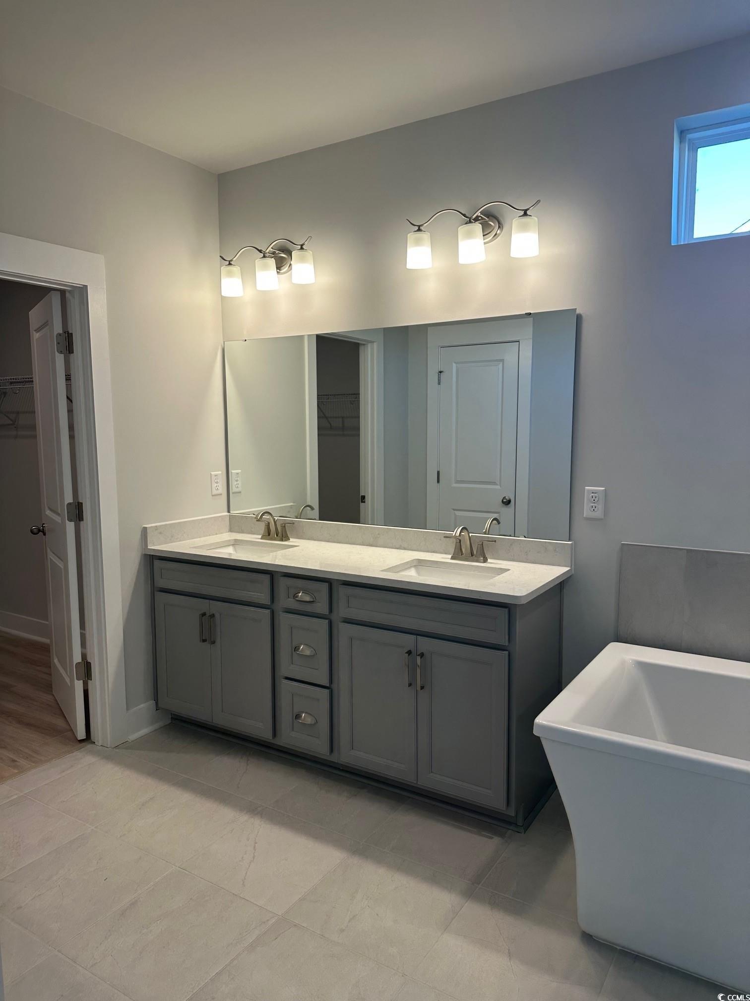 185 Northbrook Drive Murrells Inlet, SC 29576 - Photo 19 of 30 Full bath with a spacious closet, a freestanding bath, and double vanity