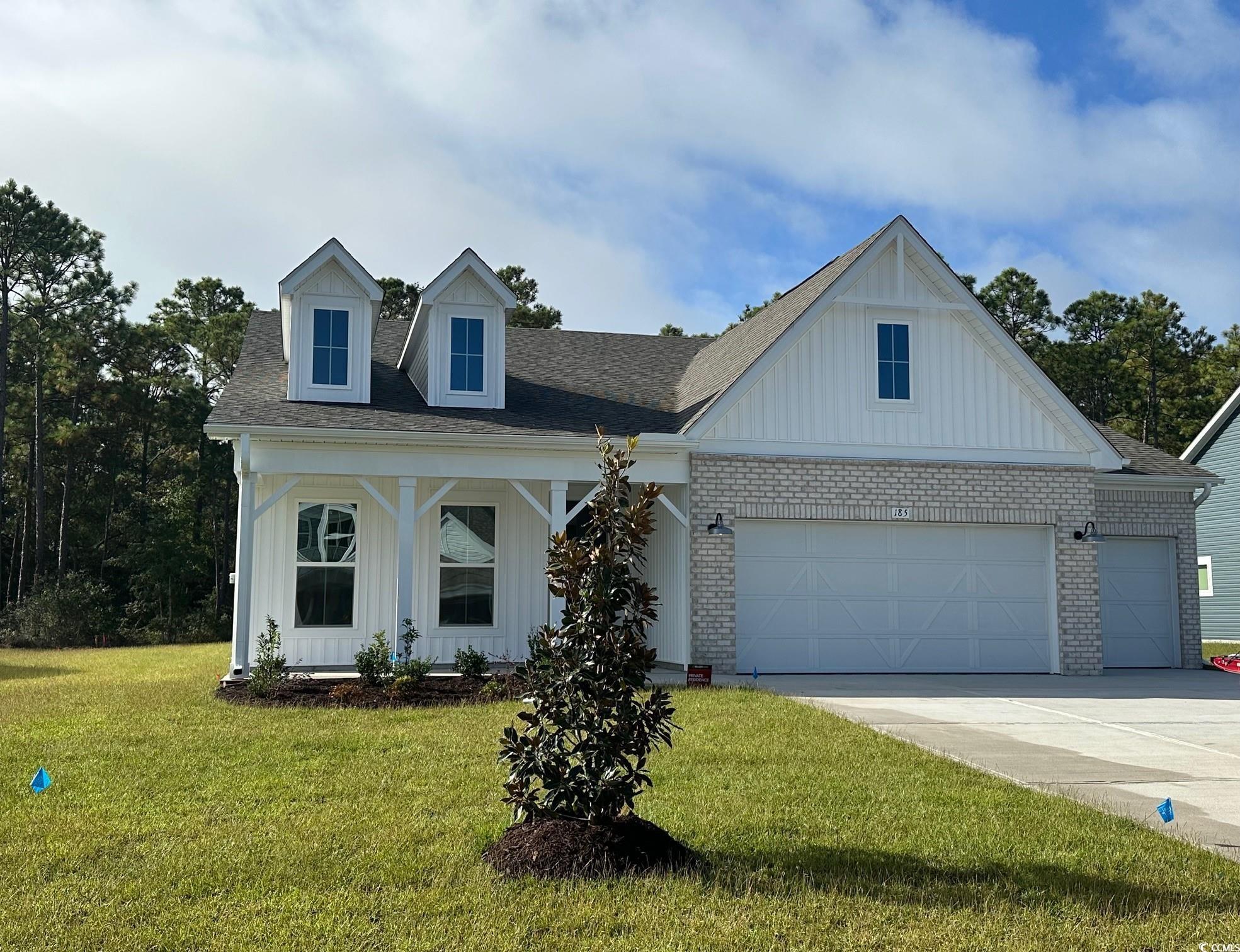 185 Northbrook Drive Murrells Inlet, SC 29576 - Photo 3 of 30 View of front of property with brick siding, board and batten siding, a porch, and a front yard