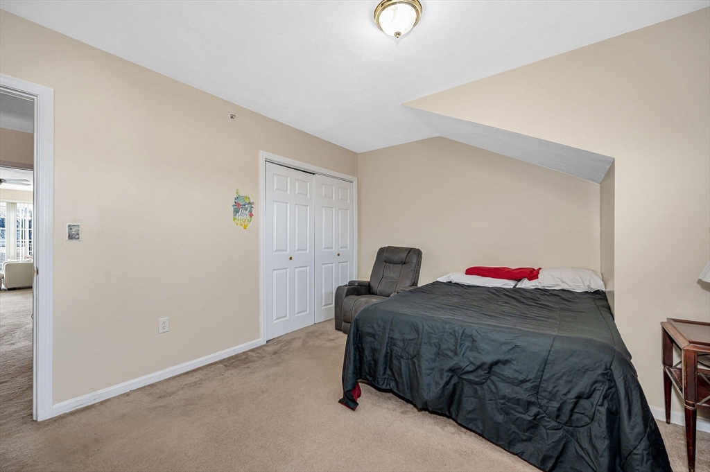 39 Broadway, Unit 305 Malden, MA 02148 - Photo 26 of 36 a bedroom with a bed and closet