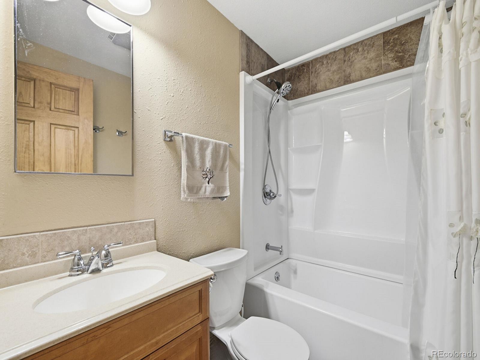 399 Conifer Drive Bailey, CO 80421 - Photo 13 of 42 a bathroom with a granite countertop sink toilet tub and shower
