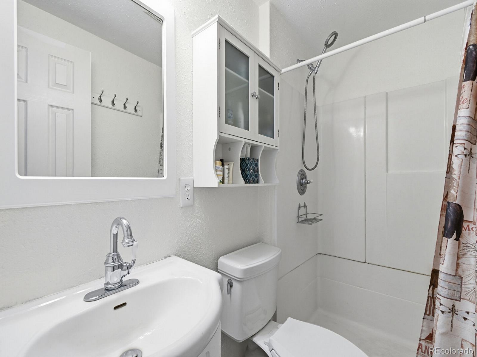 399 Conifer Drive Bailey, CO 80421 - Photo 15 of 42 a bathroom with a sink a toilet and shower