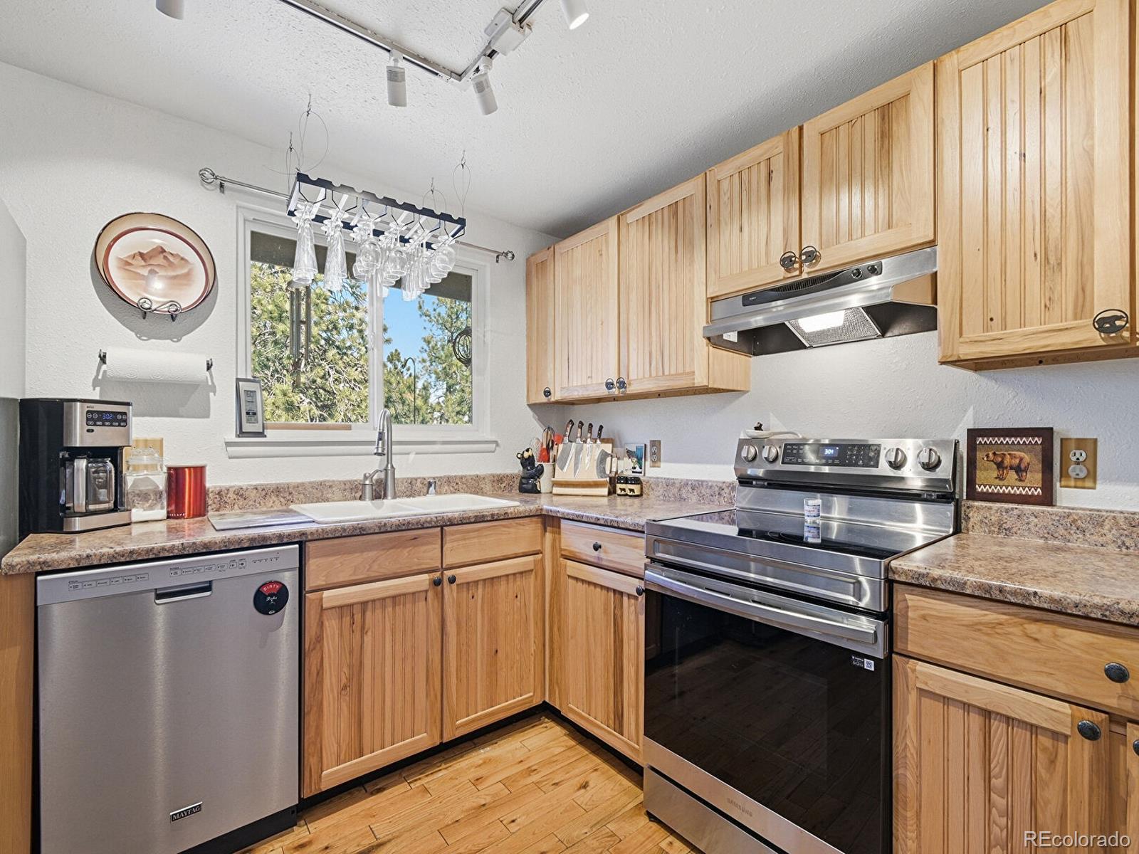 399 Conifer Drive Bailey, CO 80421 - Photo 3 of 42 a kitchen with stainless steel appliances granite countertop a sink and cabinets