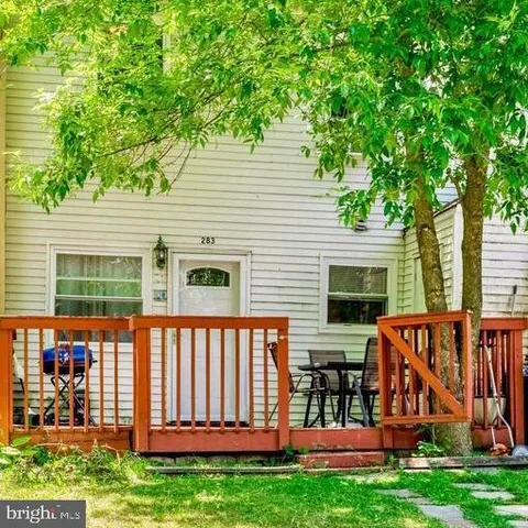 a view of a house with backyard and a tree