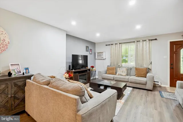 a living room with furniture and a flat screen tv