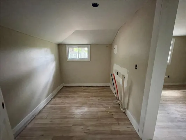 a view of hallway with stairs and wooden floor