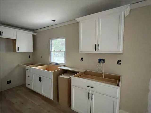 a utility room with sink dryer and window
