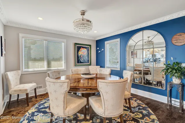 a living room with furniture a dining table and a potted plant