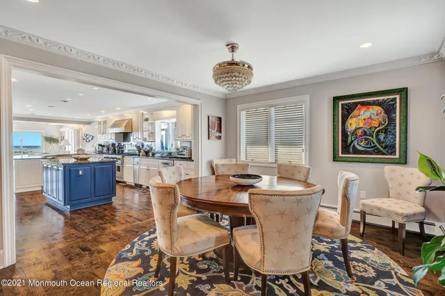 a dining room with furniture and a large window