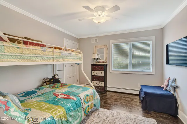 a bedroom with a bed and a bookshelf with the wooden closet